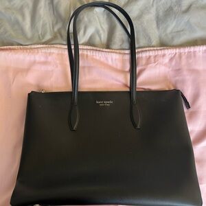 Kate Spade laptop purse. Used with some marks on the exterior.